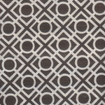 Detail of fabric in a geometric lattice print in dark brown on a white field.