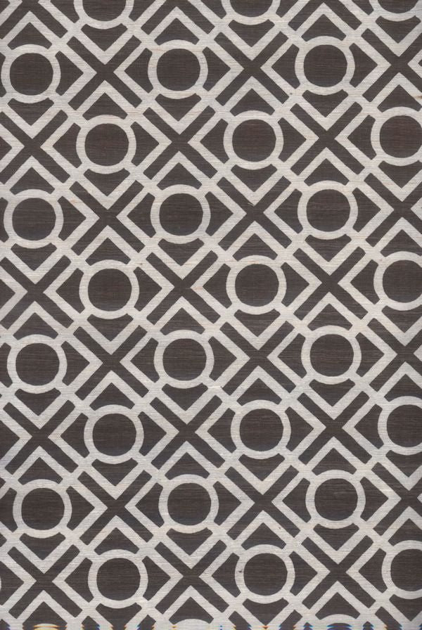 Detail of fabric in a geometric lattice print in dark brown on a white field.