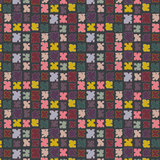 Scaled-out view of fabric in a playful patchwork quilt print in a rainbow of shades on a dark green field.