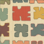 Detail of grasscloth fabric in a playful patchwork quilt print in a rainbow of shades on a cream field.