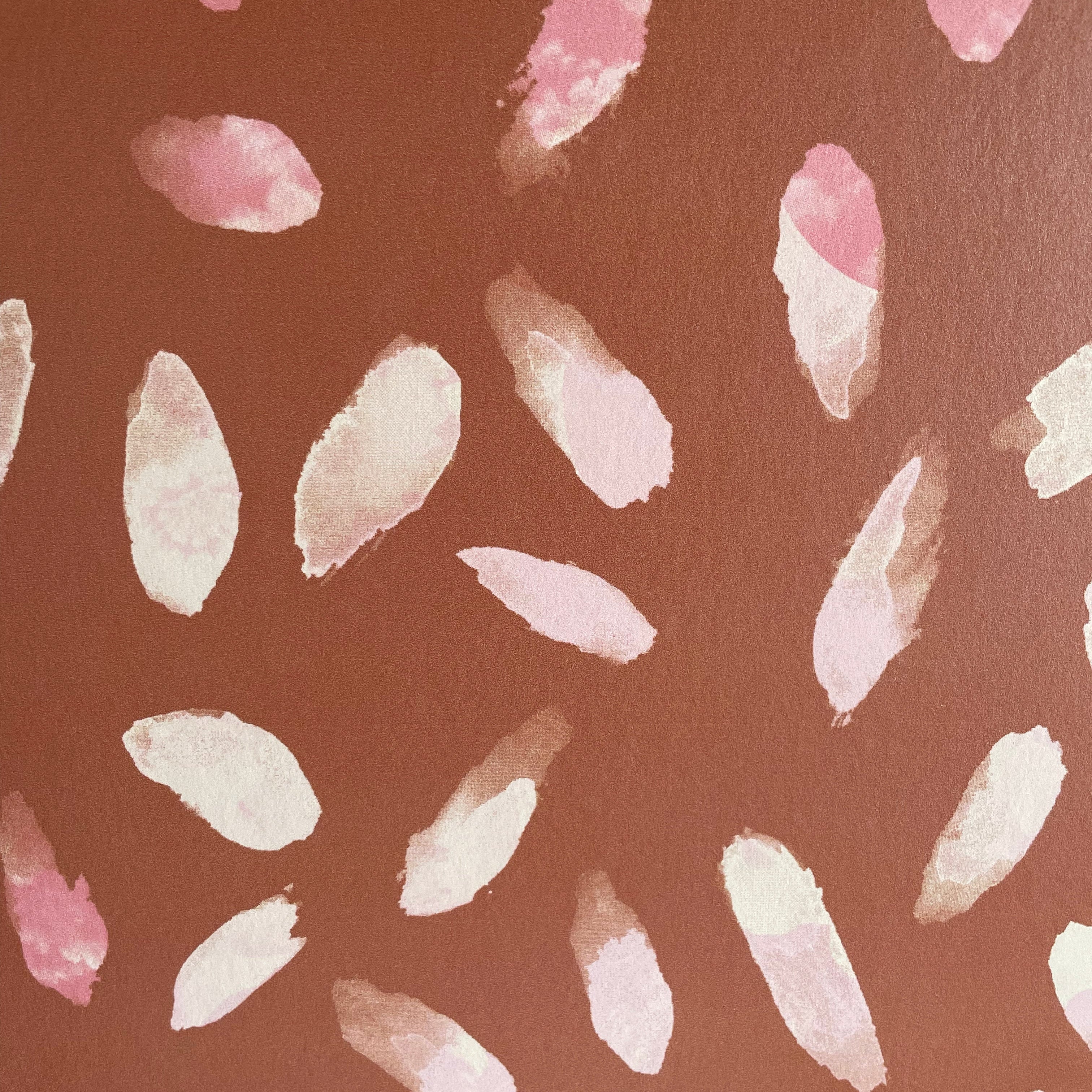 Detail of wallpaper in a playful paint blotch print in shades of pink and cream on a brown field.