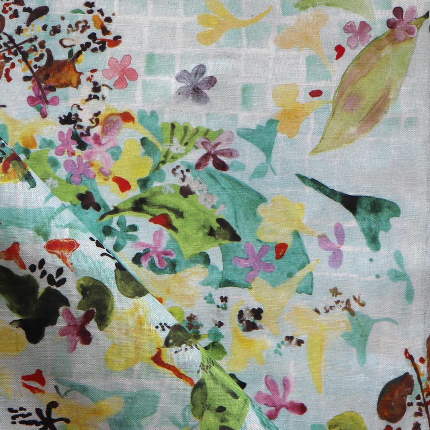 Colorful fabric with floral and leaf patterns on a blue background