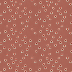 Scaled-out view of fabric in a minimal floral print in shades of pink, red and blue on a maroon field.