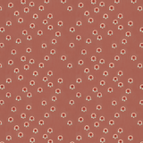 Scaled-out view of fabric in a minimal floral print in shades of pink, red and blue on a maroon field.