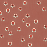 Detail of fabric in a minimal floral print in shades of pink, red and blue on a maroon field.