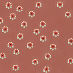 Detail of wallpaper in a minimal floral print in shades of pink, red and blue on a maroon field.