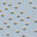 Detail of fabric in a minimal floral print in shades of gold, white and navy on a blue field.