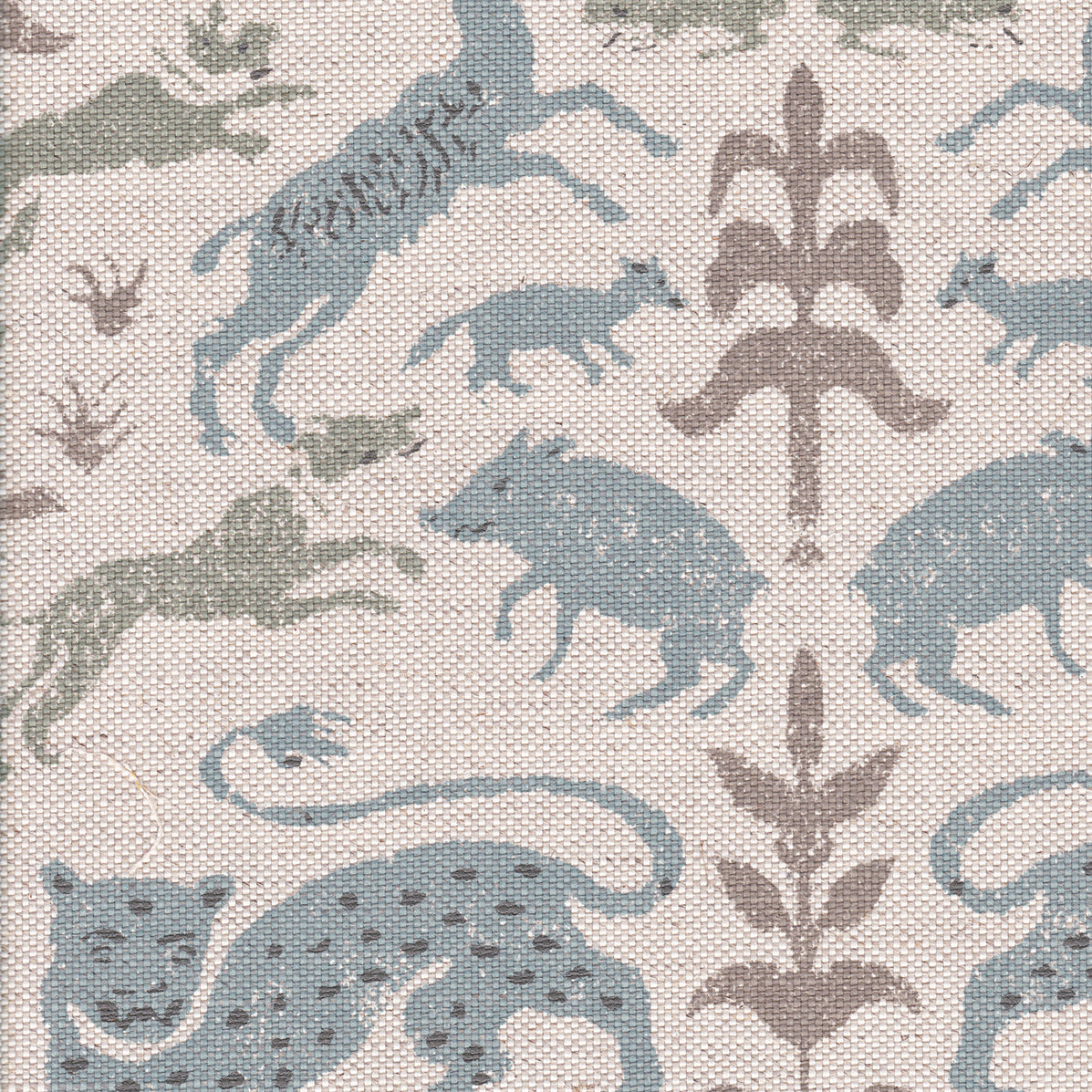 Detail of fabric in a playful animal and botanical print in brown and blue on a cream field.