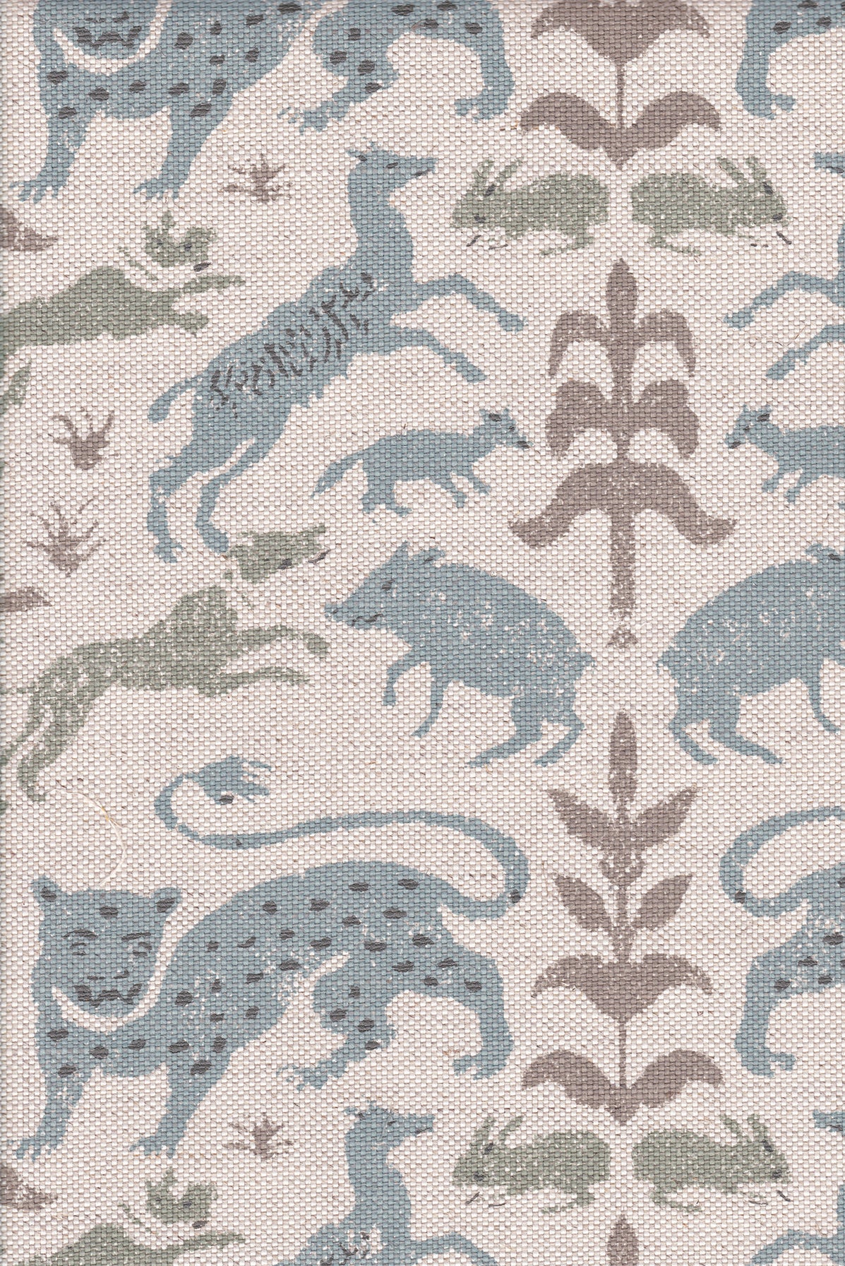 Detail of fabric in a playful animal and botanical print in brown and blue on a cream field.