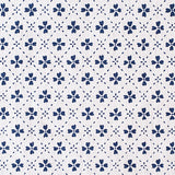 Detail of fabric in a dainty floral lattice print in navy on a white field.