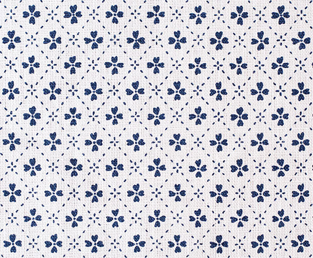 Detail of fabric in a dainty floral lattice print in navy on a white field.