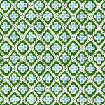 Detail of fabric in a floral lattice print in blue and green on a white field.