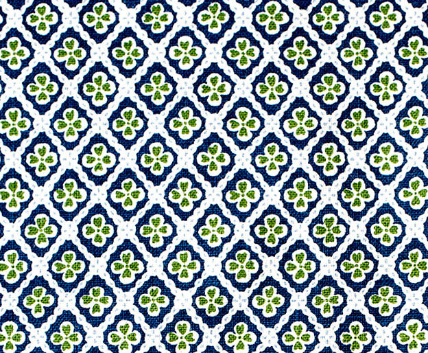 Detail of fabric in a floral lattice print in navy and green on a white field.