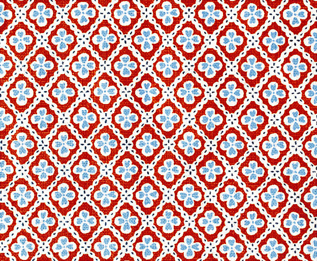 Detail of fabric in a floral lattice print in blue and red on a white field.