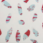 Detail of wallpaper in a playful paint blotch print in shades of red and blue on a cream field.