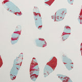 Detail of wallpaper in a playful paint blotch print in shades of red and blue on a cream field.