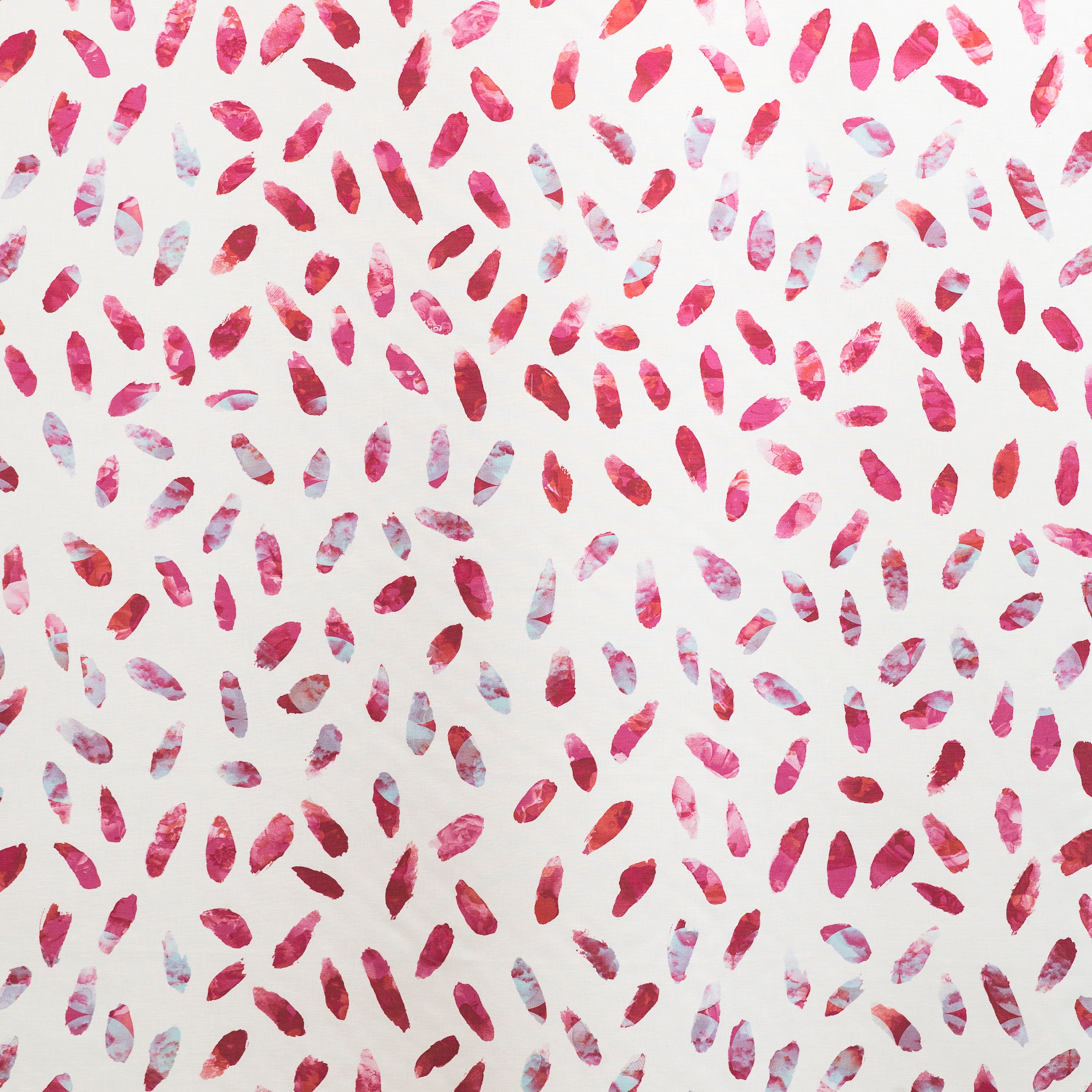 Detail of fabric in a playful paint blotch print in shades of pink and turquoise on a white field.