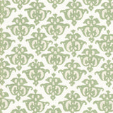 Detail of fabric in a repeating damask print in green and cream on a white field.