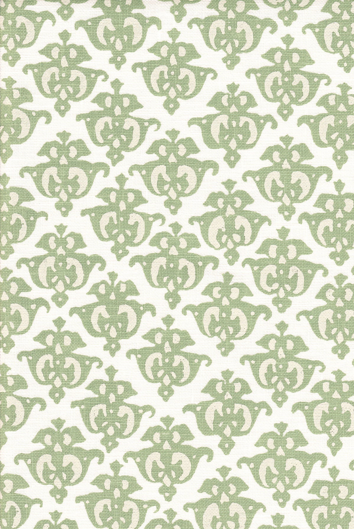 Detail of fabric in a repeating damask print in green and cream on a white field.