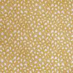 Detail of fabric in a playful repeating hoop pattern in mustard on a cream field.