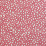 Detail of fabric in a playful repeating hoop pattern in pink on a cream field.