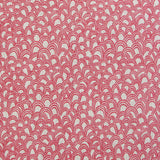 Detail of fabric in a playful repeating hoop pattern in pink on a cream field.