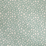 Detail of fabric in a playful repeating hoop pattern in turquoise on a cream field.