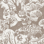 Detail of wallpaper in a playful reef print in tan on a white field.