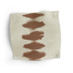Fabric swatch with brown abstract patterns on a white background