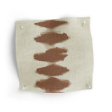 Fabric swatch with brown abstract patterns on a white background