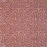 Printed fabric in a meandering hand drawn line pattern in purple on an orange field. 