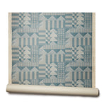 Abbot Kinney grasscloth roll: the design is geometric with triangles and squares in a teal color printed on textured grasscloth
