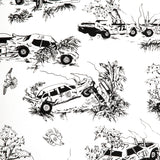 A vase of flowers stands in front of a wall covered in a playful illustrated car crash print in black on a white field.