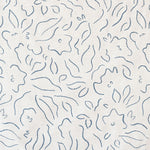 Detail of fabric in a minimalist floral print in navy on a cream field.