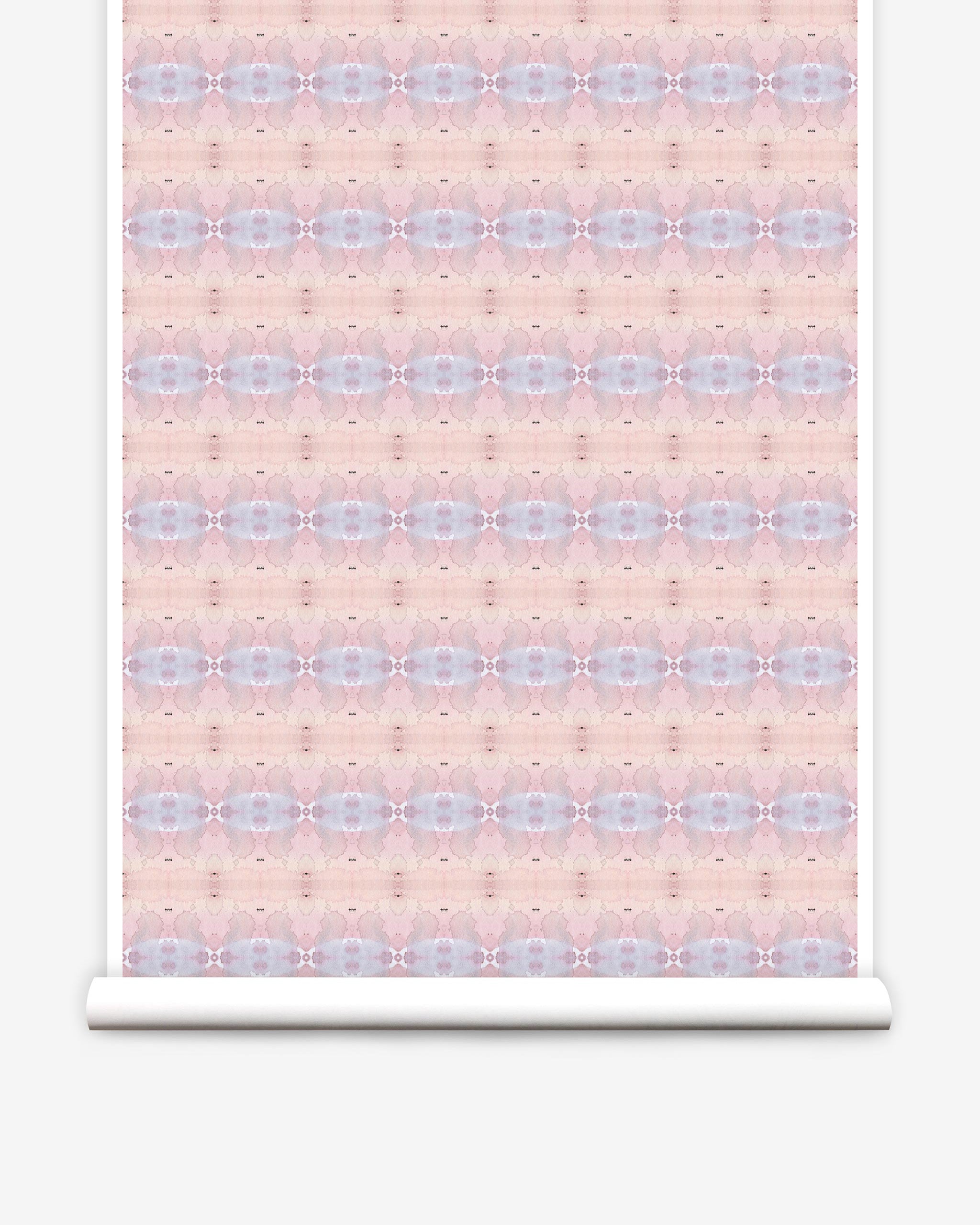 Partially unrolled wallpaper yardage in a gridded paint splatter print in shades of pink, blue, tan and white.