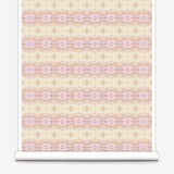 Partially unrolled wallpaper yardage in a gridded paint splatter print in shades of pink, yellow, cream and white.