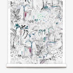 Partially unrolled wallpaper yardage in a painterly botanical print in shades of gray, white, turquoise and pink.