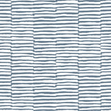 Detail of wallpaper in a broken stripe print in navy on a white field.