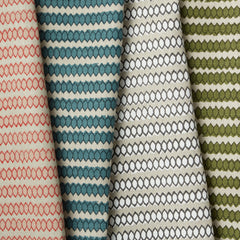 Four folded pieces of upholstery fabric, all with the same striped honeycomb pattern in pink, blue, green and neutral colors.