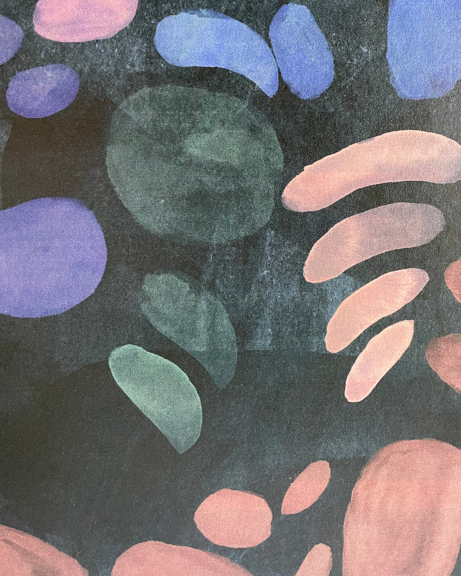Detail of wallpaper in a playful paint blotch print in shades of blue, green and pink on a black field.