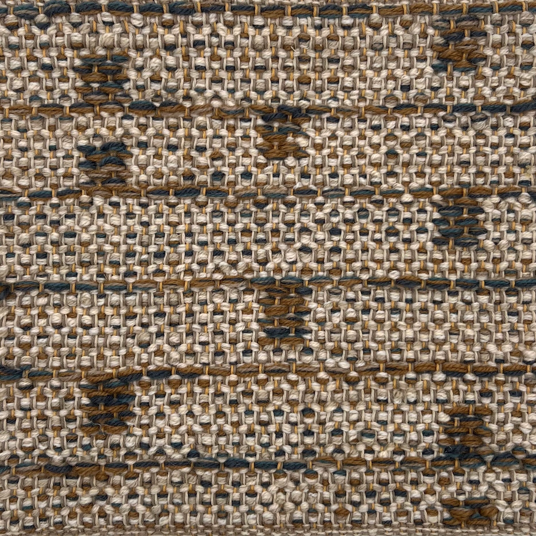 Textural flatweave rug in a modern stripe geometric design in brown and teal on a taupe field.
