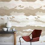 Modern interior with a red chair, table, and decorative items against a mountain-themed wallpaper.