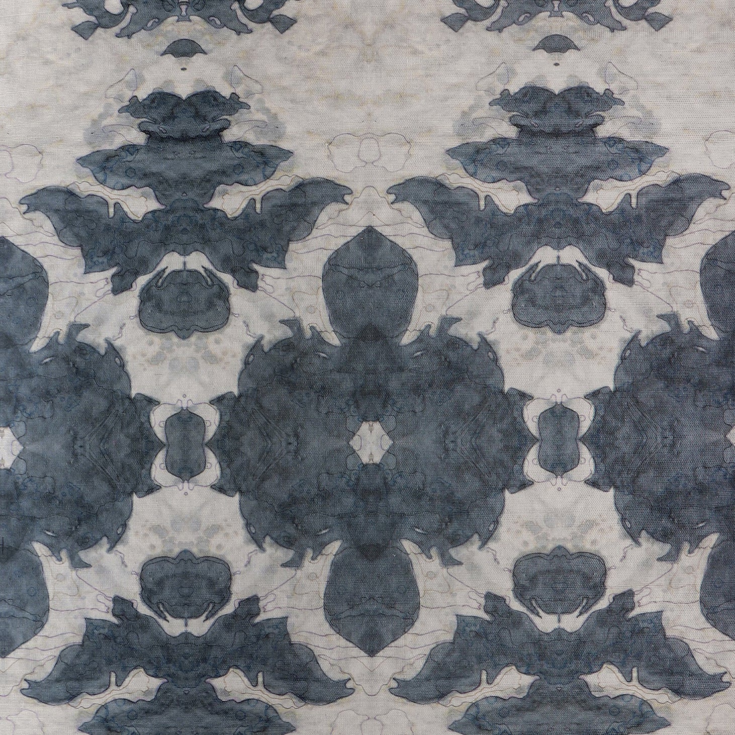Detail of wallpaper in a painterly ikat print in shades of navy and tan.