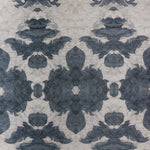 Detail of wallpaper in a painterly ikat print in shades of navy and tan.