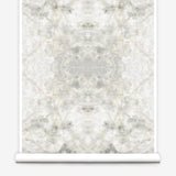 Partially unrolled wallpaper yardage in an abstract textural print in shades of cream, gray and tan.