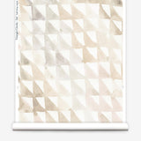 Partially unrolled wallpaper yardage in a painterly check pattern in shades of cream, tan and white.