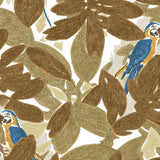 Detail of fabric in a playful botanical and parrot print in shades of bronze, brown, navy and yellow on a white field.