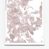 Partially unrolled wallpaper yardage in an abstract floral print in mottled pink and gray on a white field.