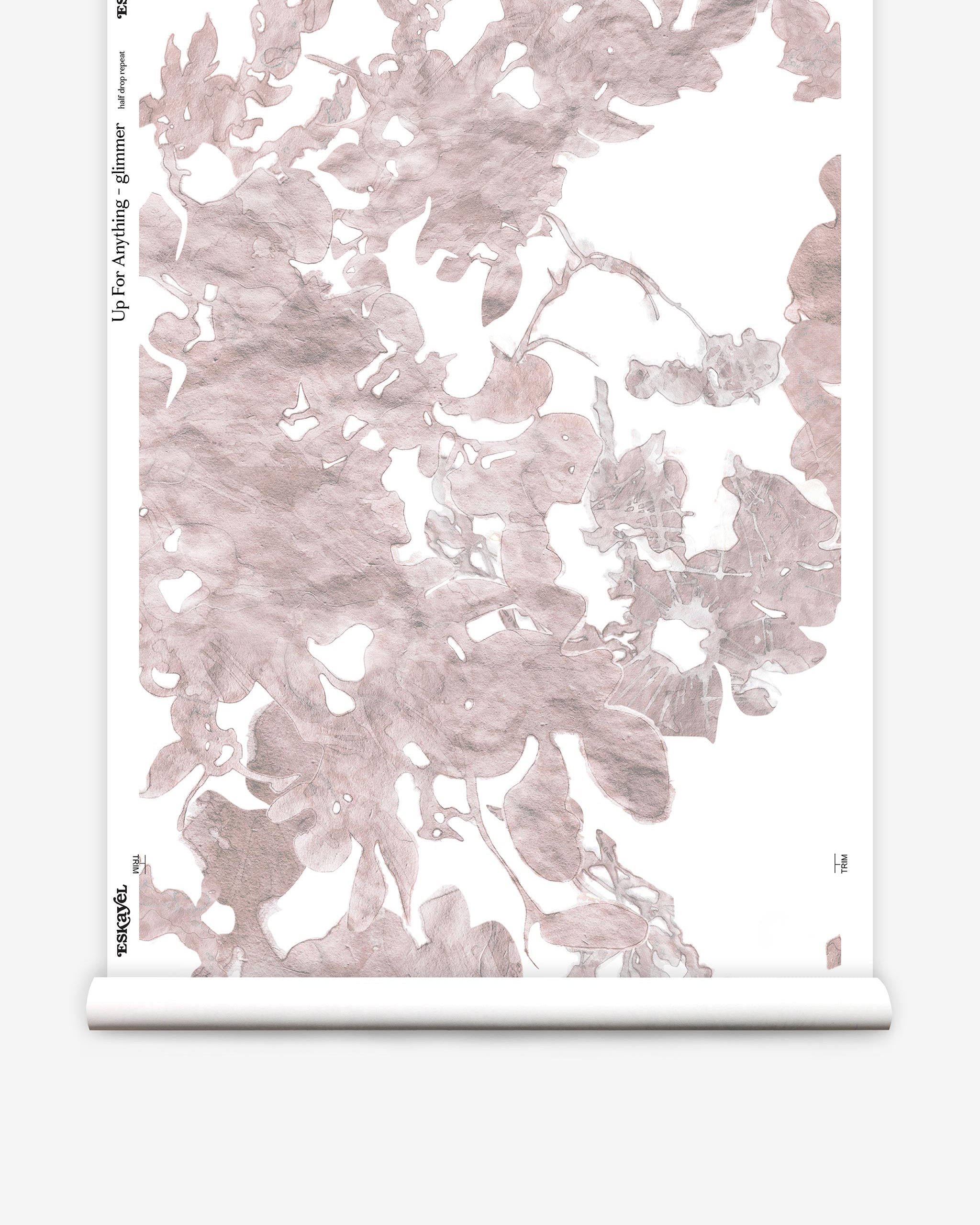 Partially unrolled wallpaper yardage in an abstract floral print in mottled pink and gray on a white field.