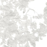 Detail of wallpaper in an abstract floral print in mottled cream and gray on a white field.